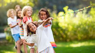 Prävention in Lebenswelten Kindergruppe macht mit Spaß Tauziehen