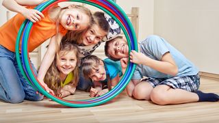Move-Factory | Grundschule Schüler und Schülerinnen schauen durch Hula-Hoop-Reifen