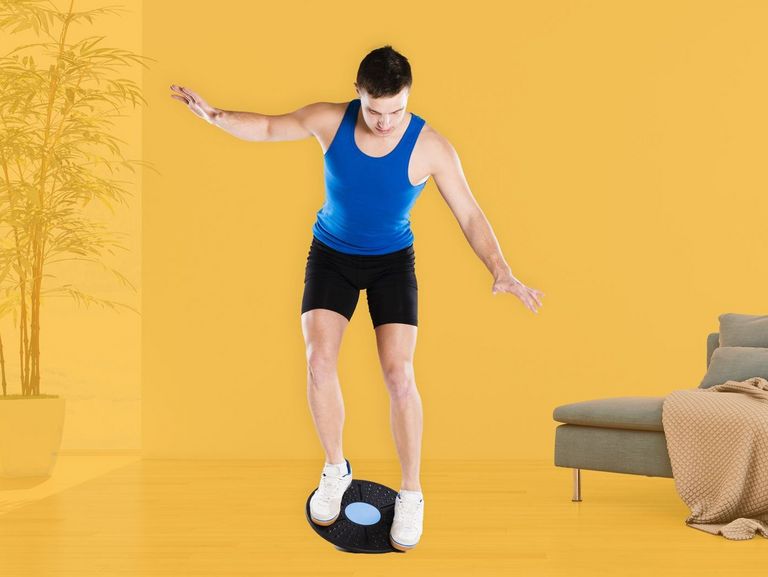 Junger sportlicher Mann auf einem Balanceboard