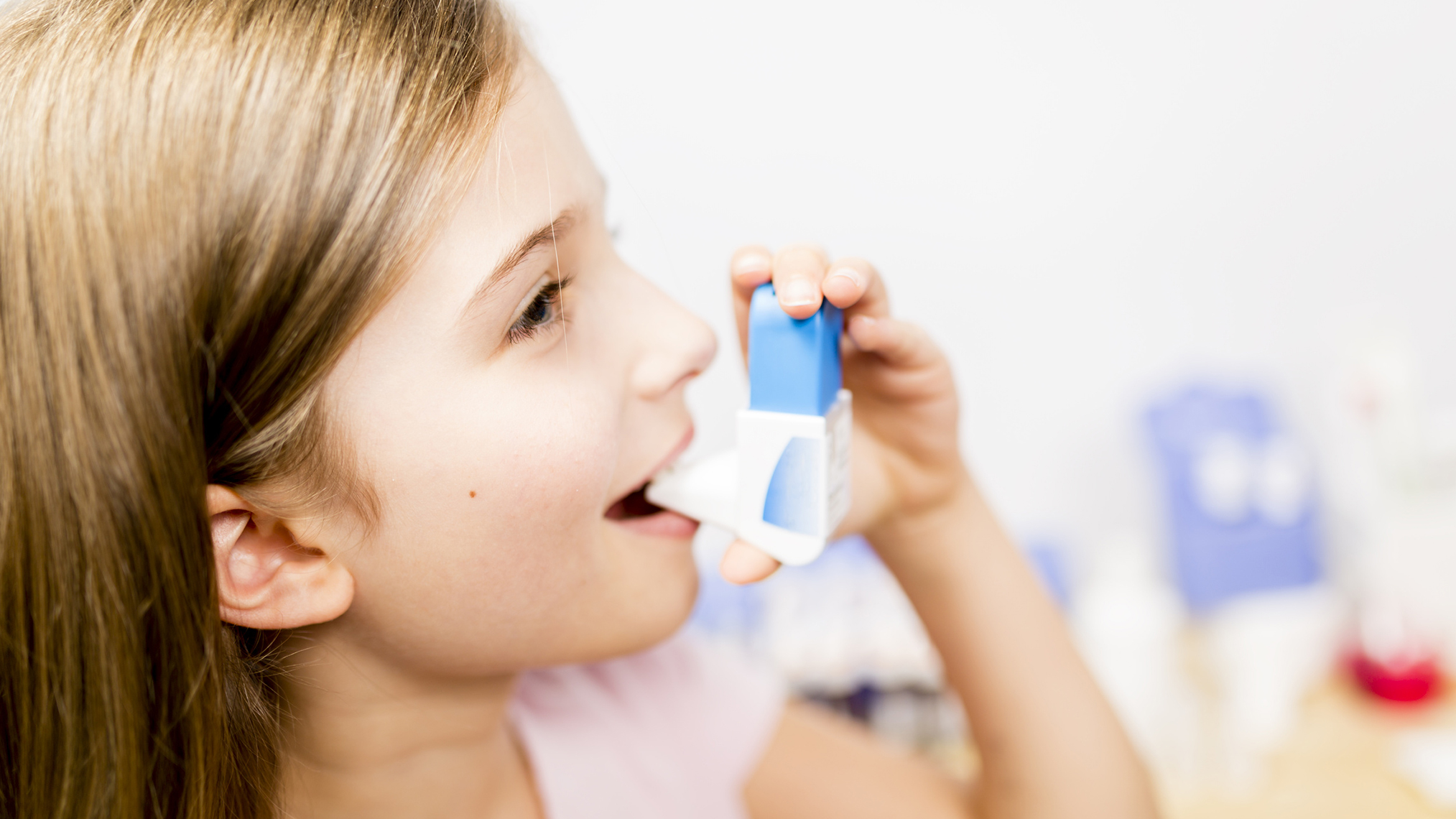 Mädchen nutzt Asthmaspray