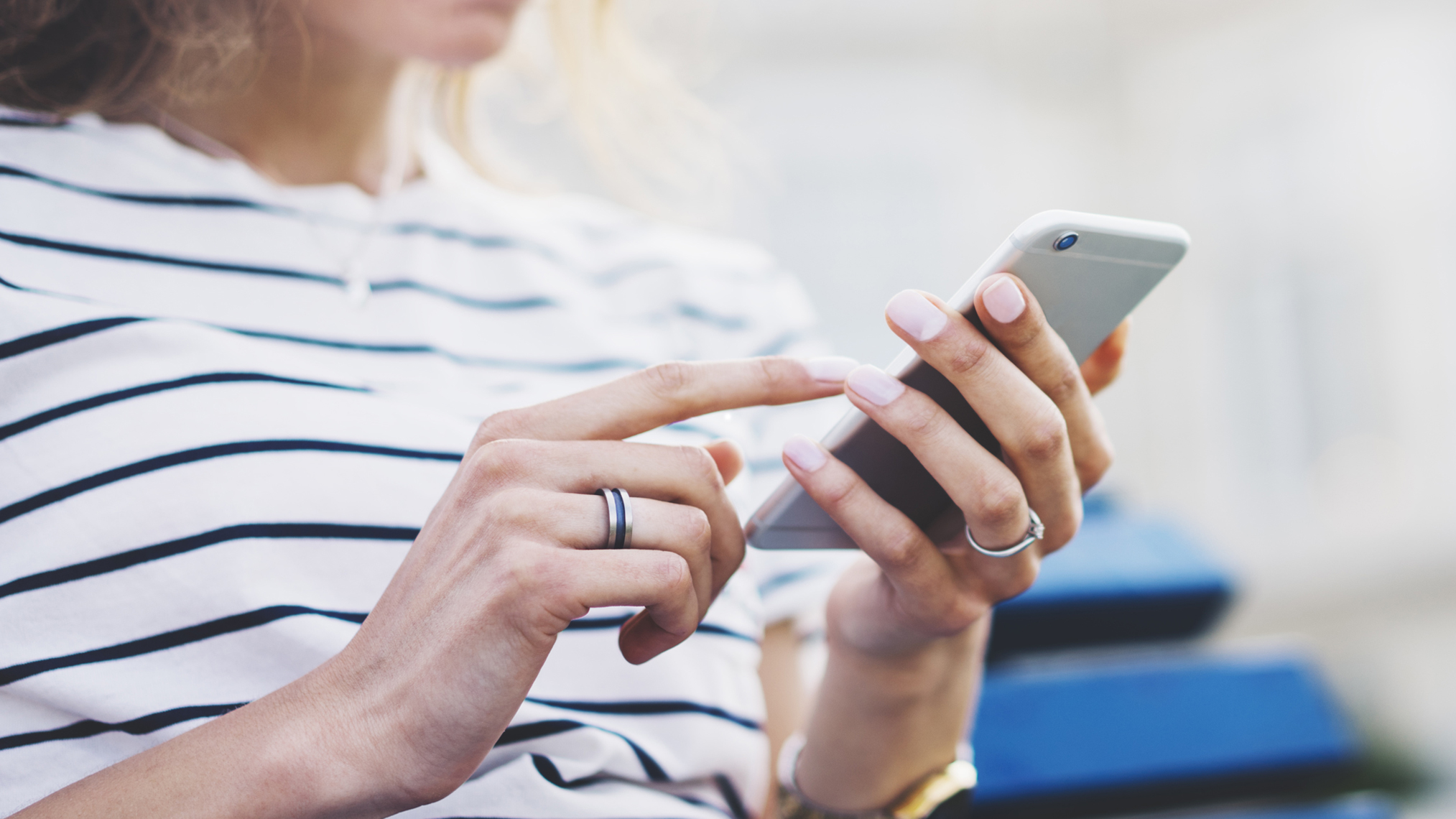 Frau schaut auf ihr Smartphone in der Hand