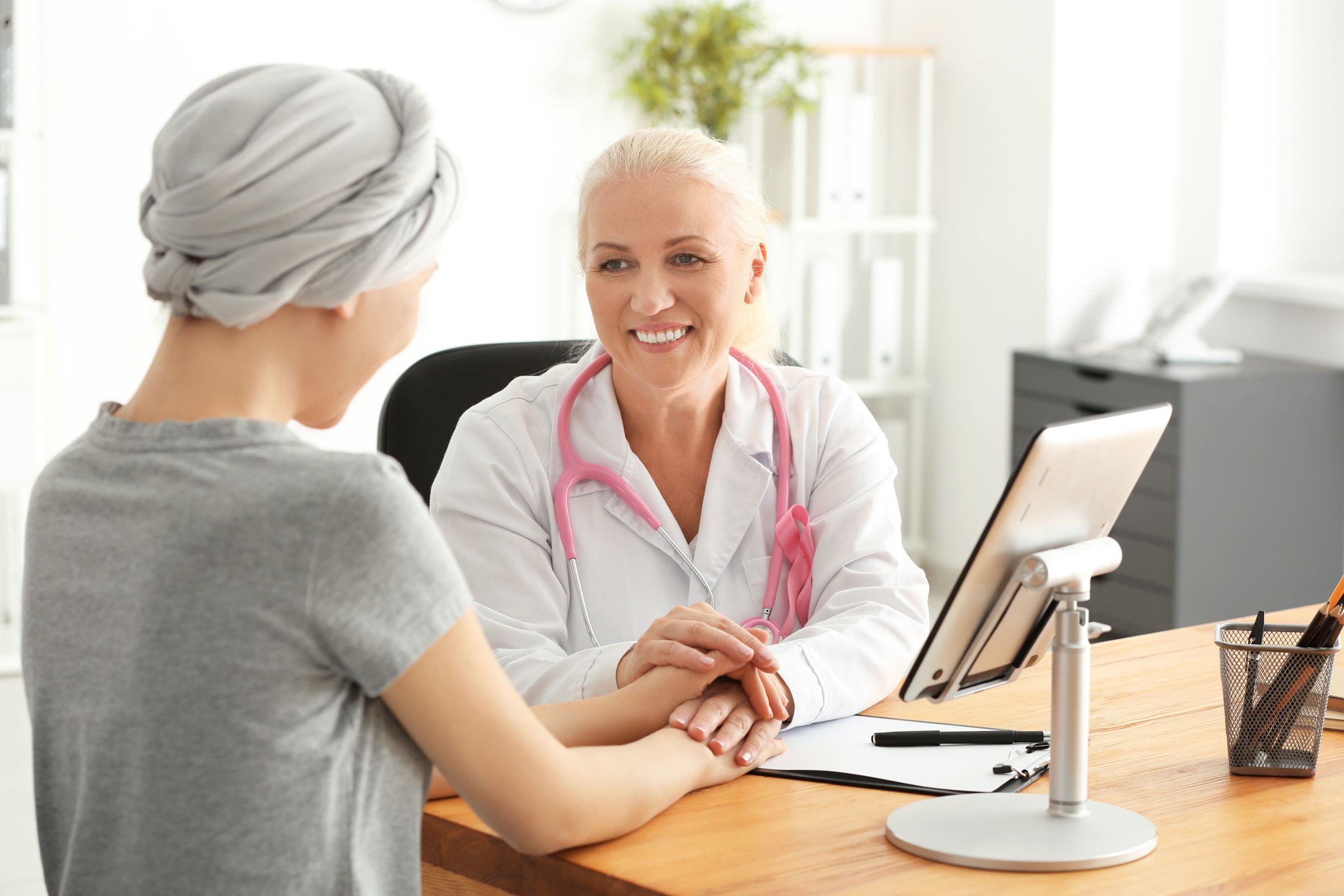 Frau nach einer Chemotherapie erhält bei einer Ärztin gute Nchrichten